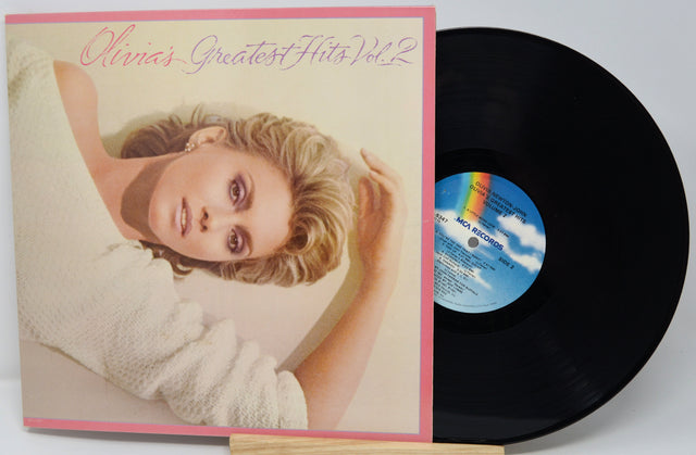 Vinyl record with cover featuring a woman's face and 'Olivia's Greatest Hits Vol. 2' text.