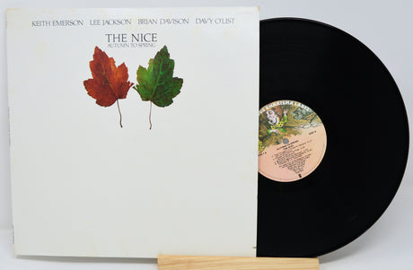 Vinyl record with a cover featuring leaves on a white background