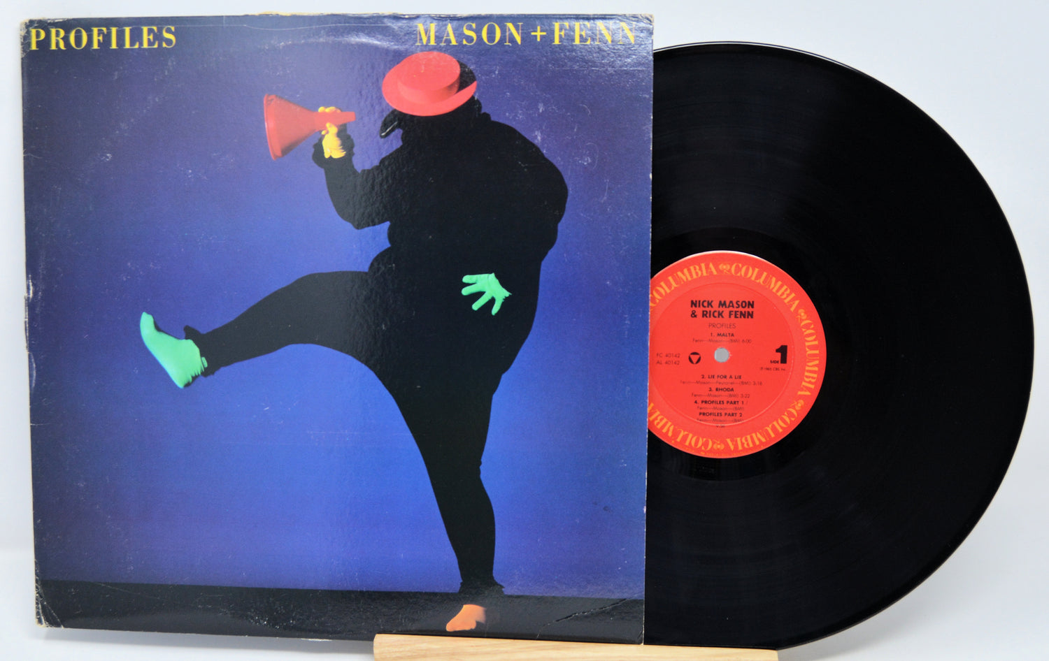 Vinyl record with cover featuring a silhouette of a person and a megaphone on a blue background.