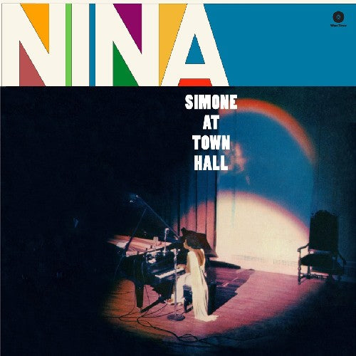 Nina Simone performing live at piano under spotlight at Town Hall, album cover.
