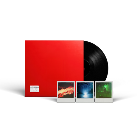A vinyl record package on a white background, featuring a large red sleeve, a partially visible black record, and three small instant-style photo prints in front. 