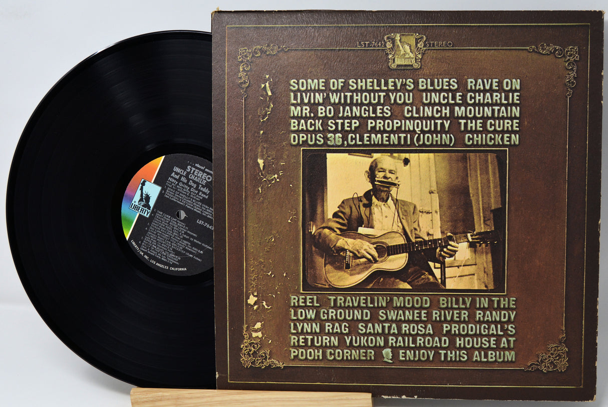 Vinyl record with its cover featuring a vintage-style image of a man playing guitar.