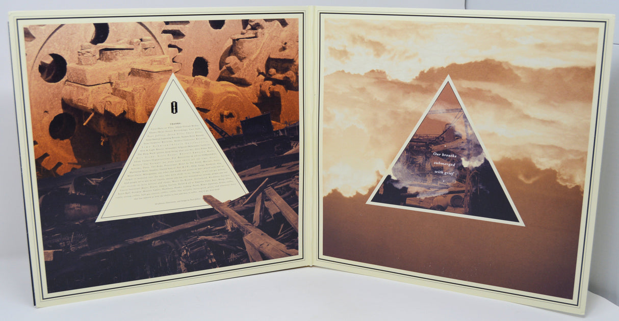 Gatefold interior of the Northless World Keeps Sinking vinyl, showing industrial artwork and lyrics.