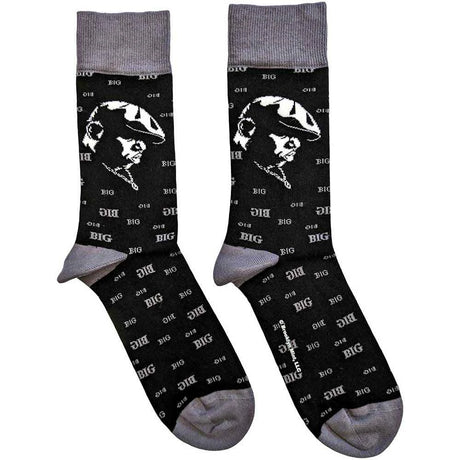 Black socks with white graphic design showing a side portrait of Biggie Smalls and gray toes and cuffs on a white background