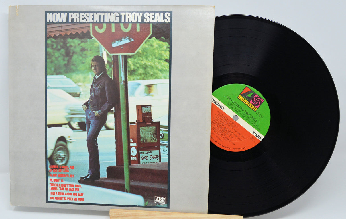 Front cover and vinyl record of 'Now Presenting Troy Seals' LP with Troy Seals by a stop sign