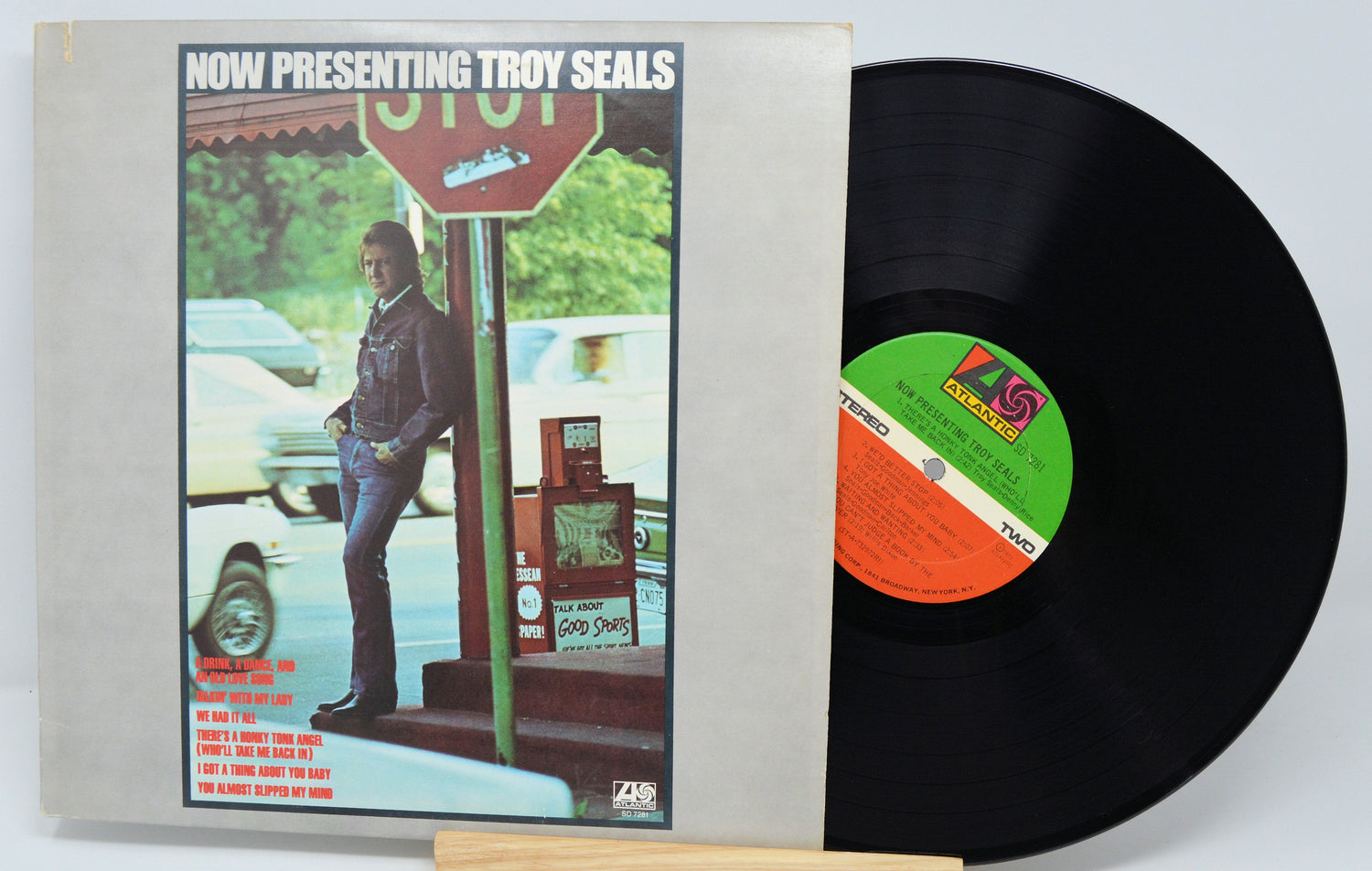 Front cover and vinyl record of 'Now Presenting Troy Seals' LP with Troy Seals by a stop sign