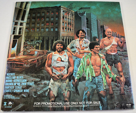 Back cover illustration of Nuclear Blues album with band in torn clothes and ruined city