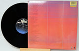 Vinyl record with a colorful sleeve on a white background
