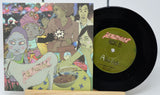 Vinyl record with colorful cover featuring illustrated characters and a green label.