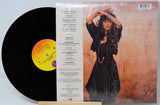 Vinyl record with a person on the cover and tracklist on the back
