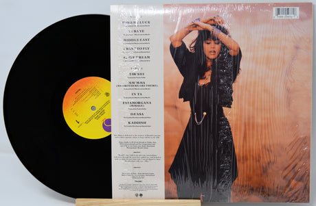 Vinyl record with a person on the cover and tracklist on the back