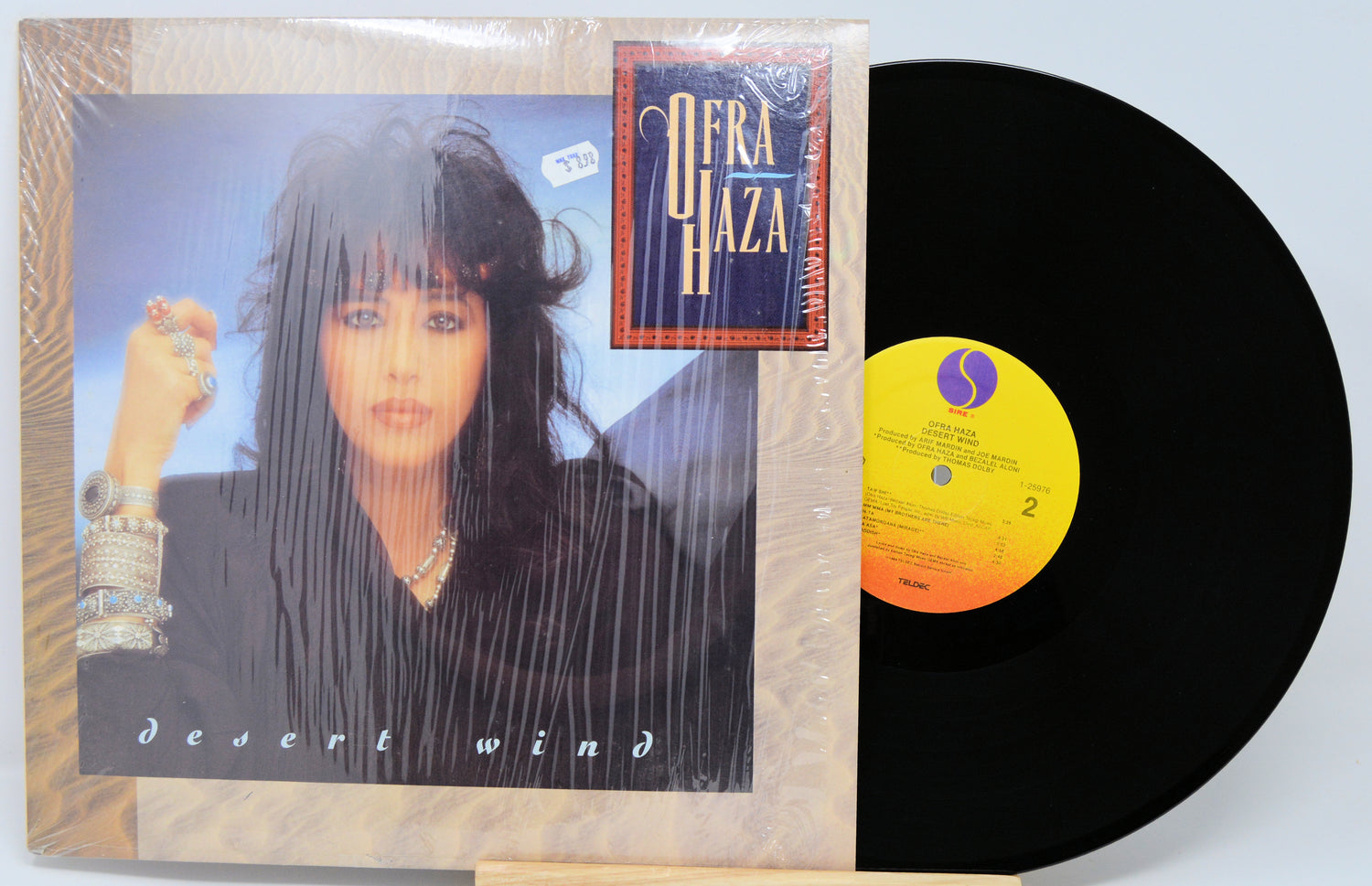 Vinyl record with cover featuring a woman's face and album details on a light blue background