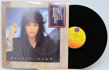 Vinyl record with cover featuring a woman's face and album details on a light blue background