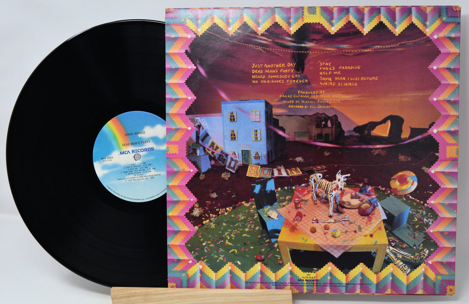 Vinyl record with a colorful cover featuring a scene of a party and text.