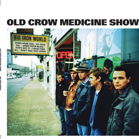 Album cover for 'Old Crow Medicine Show' titled 'Big Iron World' with a group of people standing on a sidewalk in front of a store.