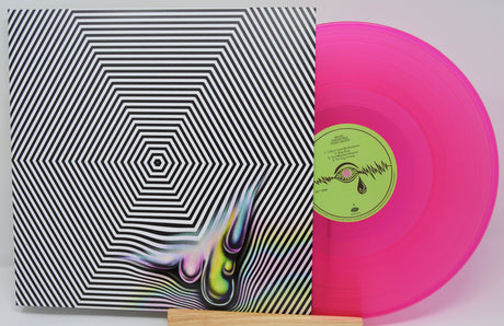 Vinyl record with pink disc and black and white cover featuring a colorful design.