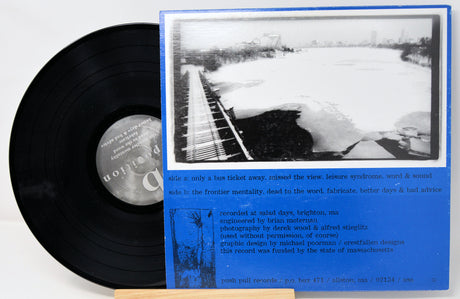 Vinyl record with a blue cover featuring black and white images and text.