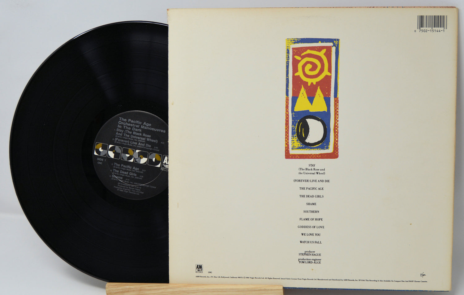 Vinyl record with cover displaying a colorful album design on a white background
