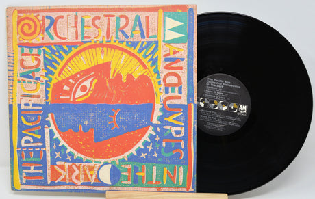 Vinyl record with colorful cover featuring text and abstract designs