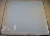 Plain white vinyl record sleeve in original shrink wrap, slightly aged