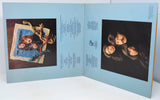 Album cover with two portraits of a woman on a light blue background