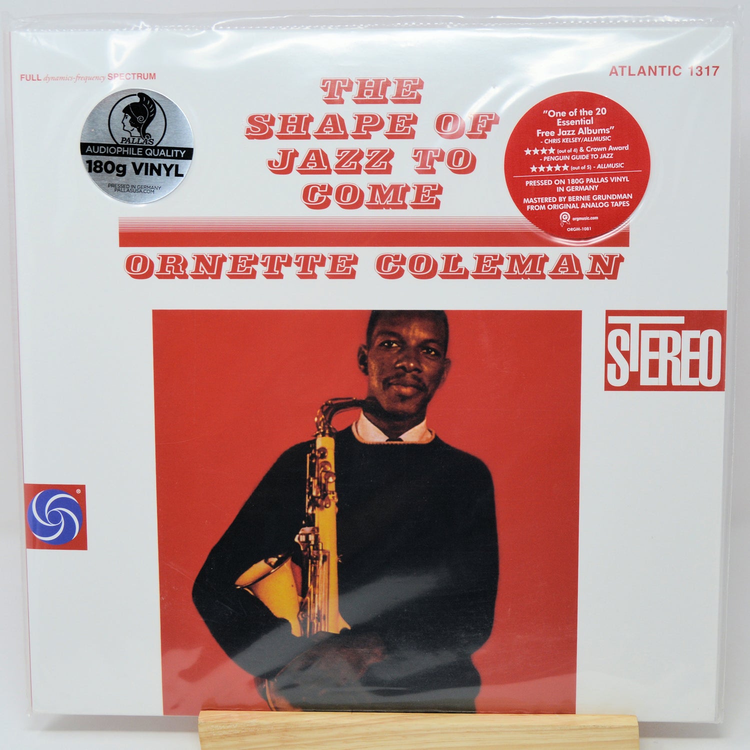The Shape of Jazz to Come vinyl record album by Ornette Coleman, Atlantic Records, 12-inch LP, sealed in its original plastic shrink wrap. The cover features a white background with red text, a red central panel containing a photo of Ornette Coleman holding a saxophone, and a red circular 'Stereo' logo.