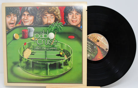 Vinyl record with a game-themed cover featuring faces and a green playing field.