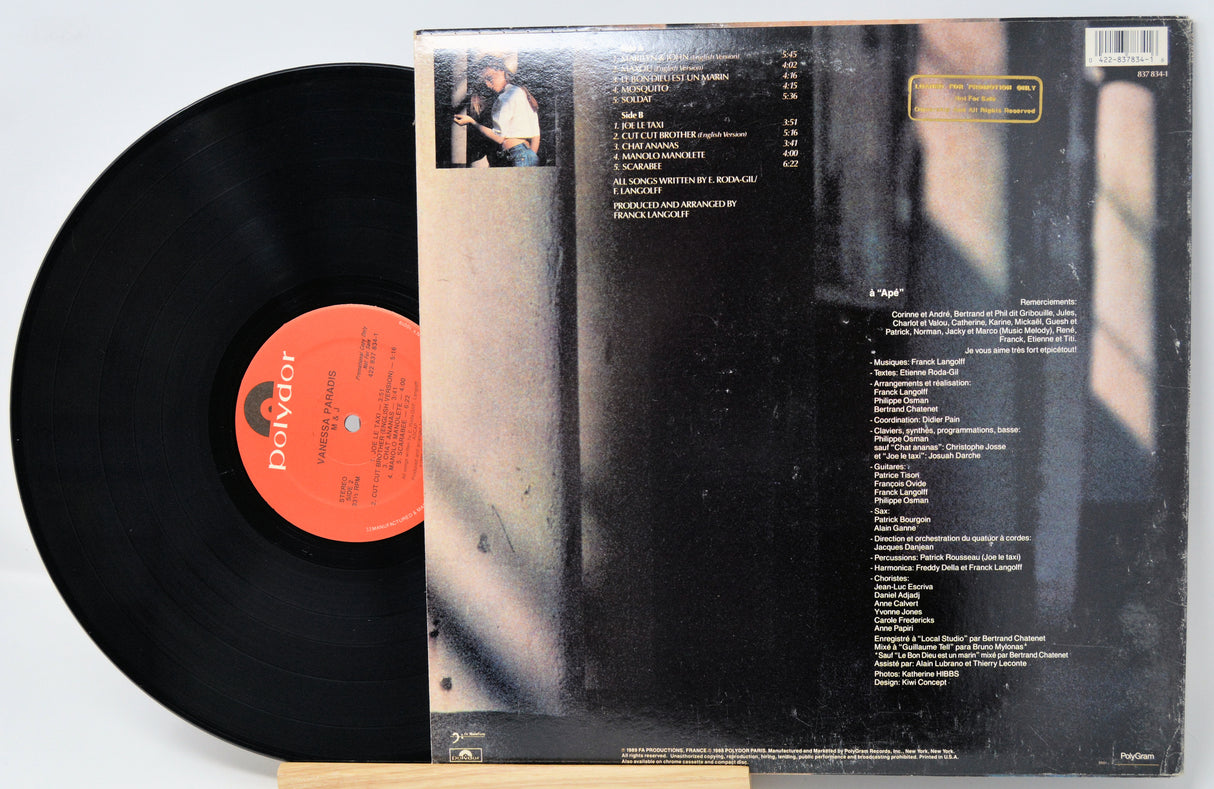 Vinyl record with red label and cover showing text on a white background