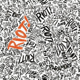 Pattern of the word 'RIOT!' in various styles with 'PARAMORE' branding.