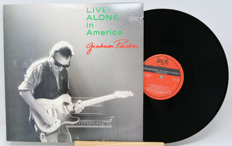 Vinyl record with cover featuring a musician and text 'Live! Alone in America' by Graham Parker.