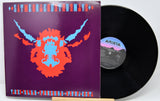 Vinyl record with a colorful cover featuring a face design on a purple background.