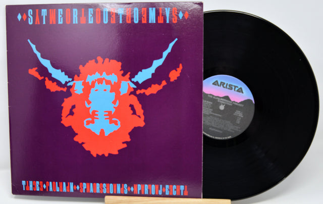 Vinyl record with a colorful cover featuring a face design on a purple background.