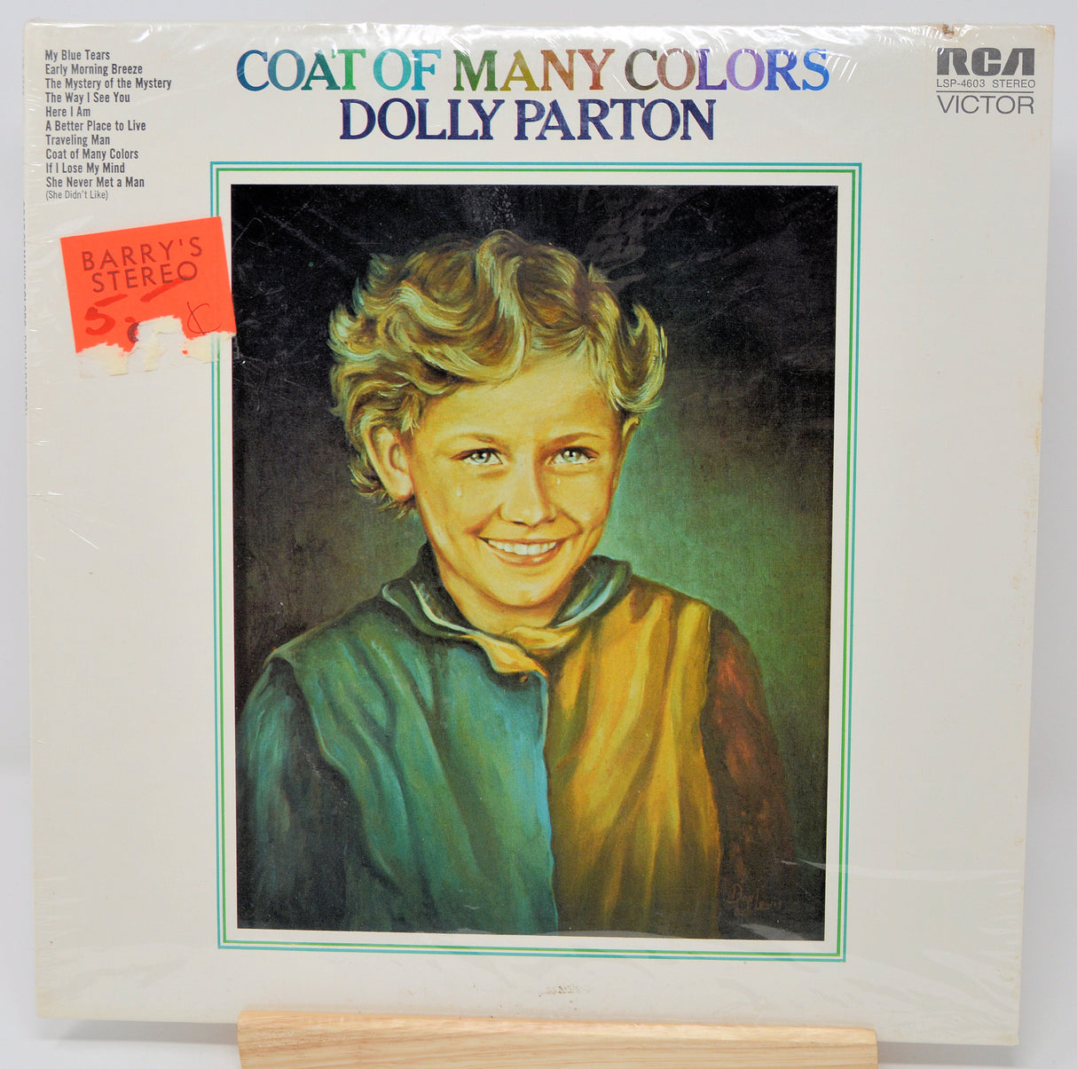 Vinyl record cover for 'Coat of Many Colors' by Dolly Parton with a portrait illustration on the front.
