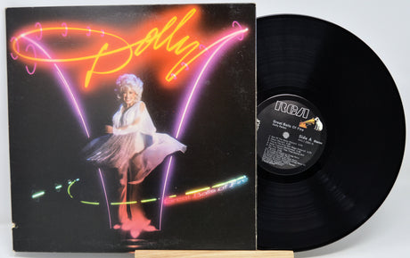 Vinyl record with cover featuring a neon-style design and a person on stage.