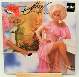 Album cover featuring a woman in a pink dress with decorative elements and text.
