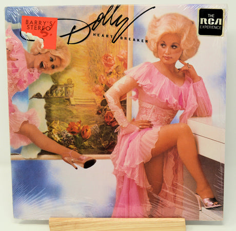 Album cover featuring a woman in a pink dress with decorative elements and text.