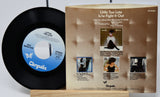 Vinyl record and its cover with 'Chrysalis' branding on a white background