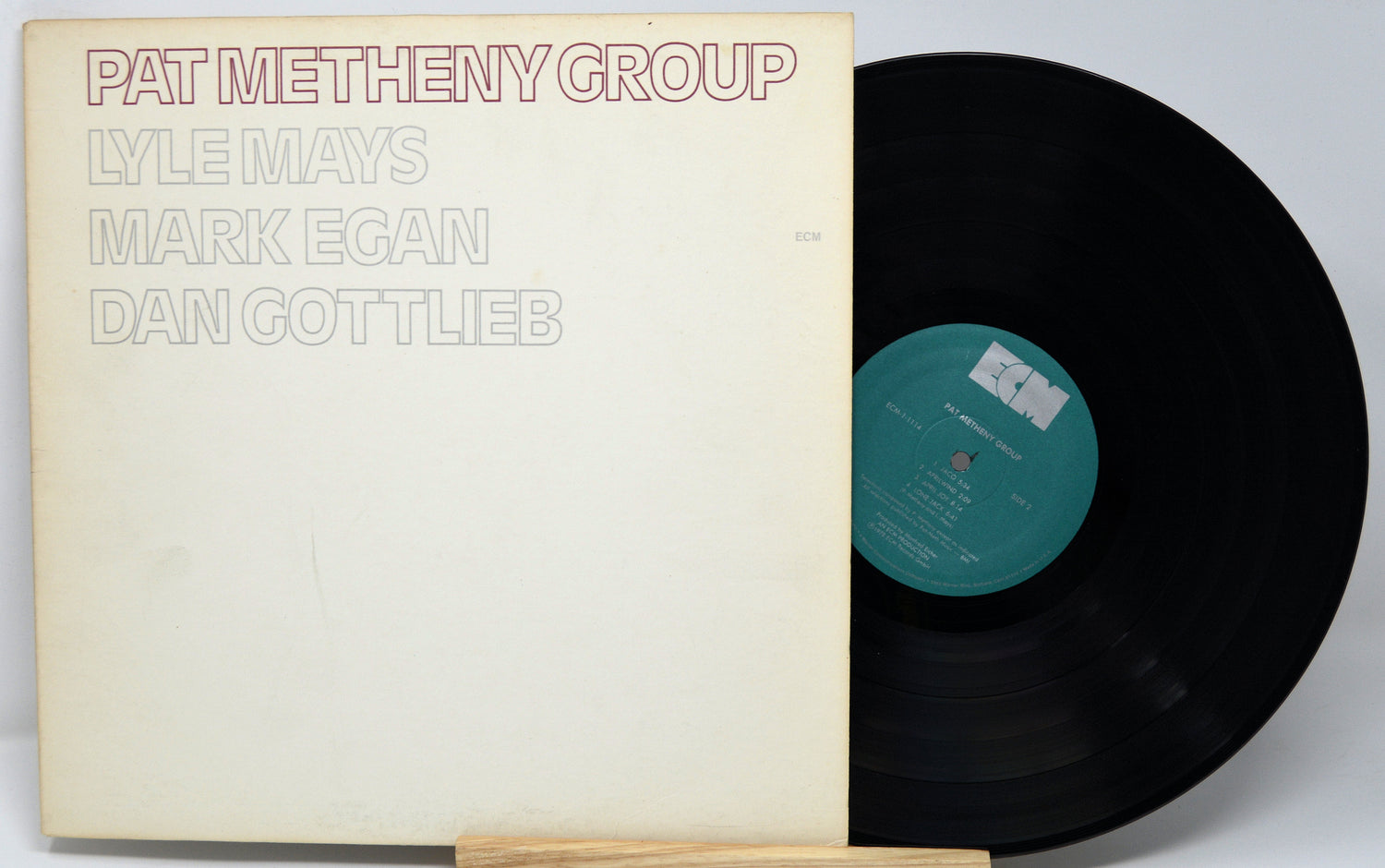 Vinyl record with cover featuring 'Pat Metheny Group' and other names on a white background