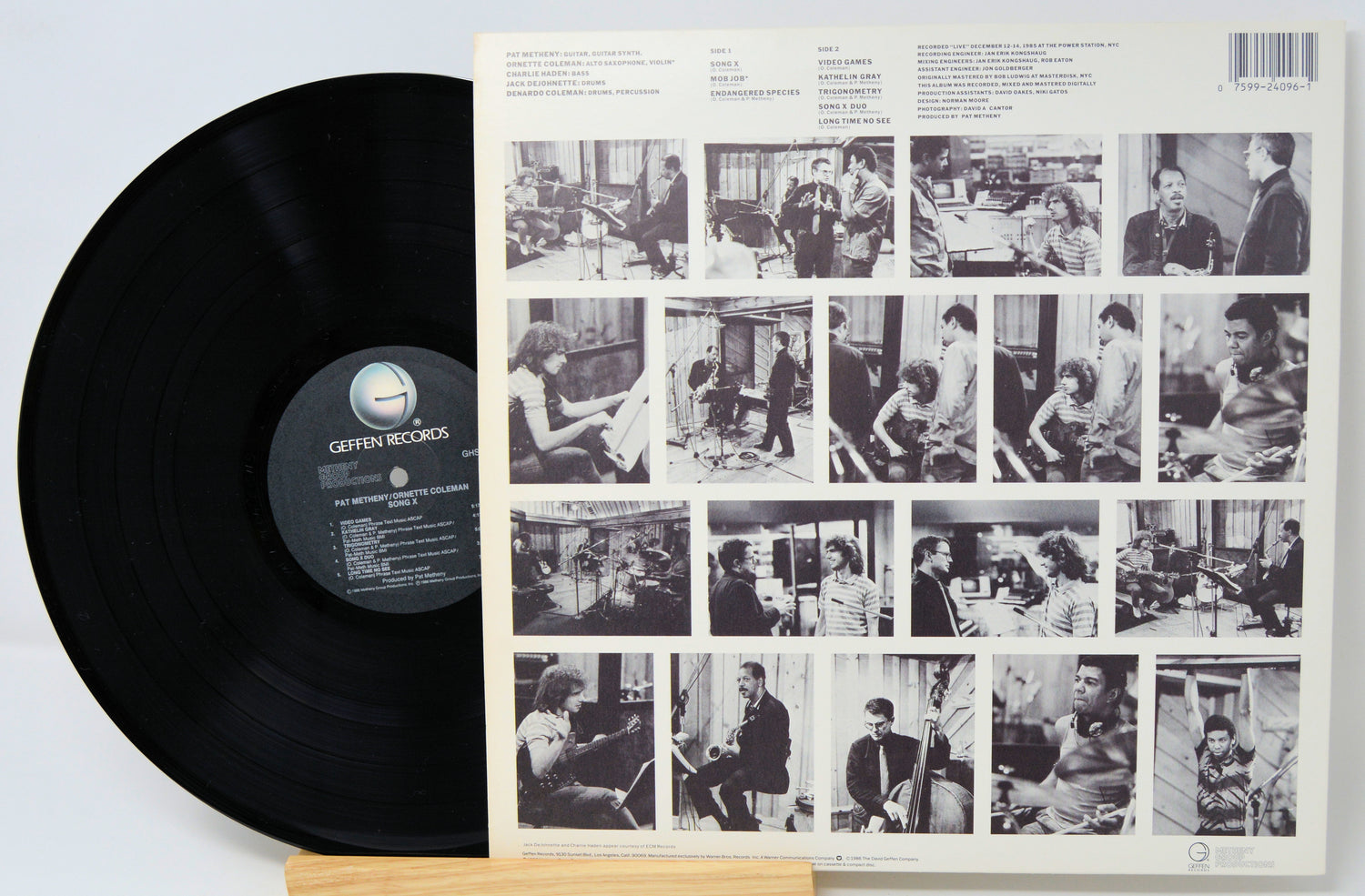 Vinyl record with a black label and a cover featuring black and white photos of people.