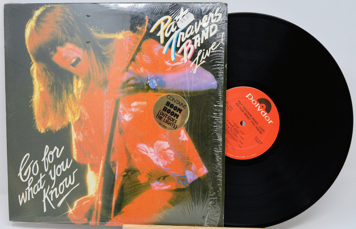 Pat Martino Band Live 'Go for what you Know' vinyl record LP with its illustrated cover sleeve and a black record partially pulled out, showing the orange center label.