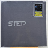 A square dark gray album or book-style package with large embossed 'STEP' lettering and a small 'IMPEX' sticker in the top-right corner, photographed against a plain light background.