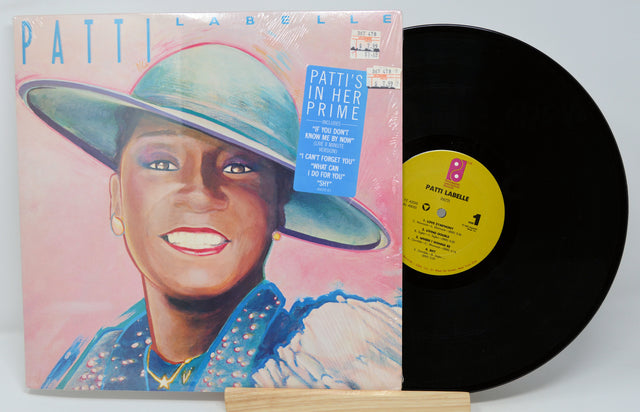 Vinyl record with cover featuring a person wearing a hat on a white background
