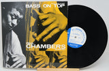 Vinyl record album for Paul Chambers Quartet's 'Bass on Top' with the LP partially pulled from the jacket, showing the black record, blue-and-white center label, and album cover artwork.