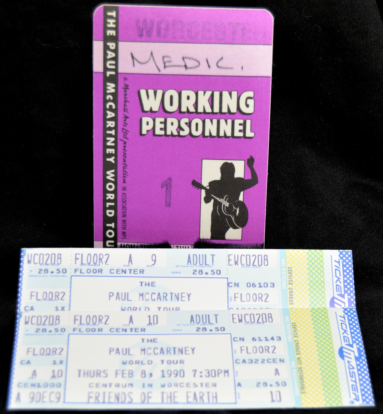 Purple 'Working Personnel' pass and concert ticket for Paul McCartney's 1990 World Tour on a black background