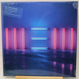Paul McCartney 'New' 12-inch vinyl record album cover, sealed in plastic shrink wrap and displayed on a wooden stand against a white background.