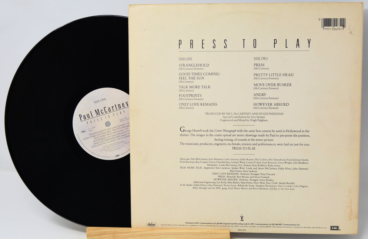 Vinyl record with cover displaying tracklist on a light gray background