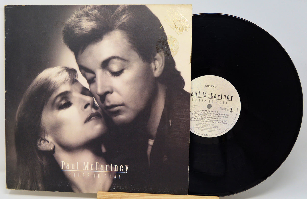 Vinyl record with cover featuring a close-up of a man and woman, and 'Paul McCartney' branding.
