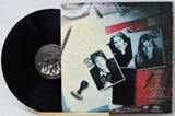 Vinyl record with a colorful cover featuring black and white photos of a couple.