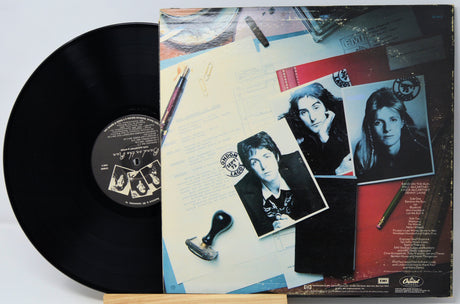 Vinyl record with a colorful cover featuring black and white photos of a couple.