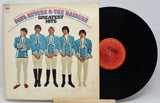 Vinyl record with cover featuring a group of five men in matching outfits on a white background